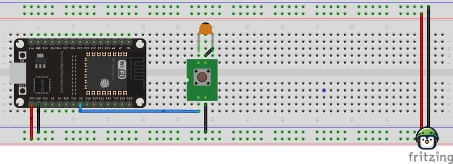 Close-up of a breadboard showing an RC circuit connected to an ESP32, with a resistor and capacitor used for button debouncing.