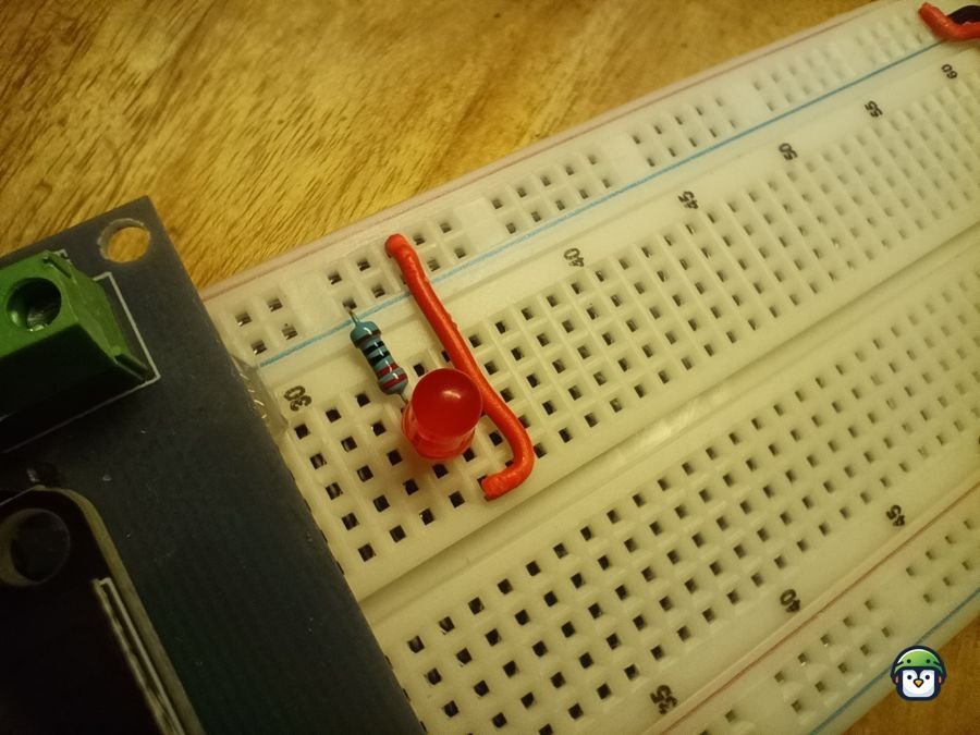 A basic LED and resistor connected to the breadboard.
