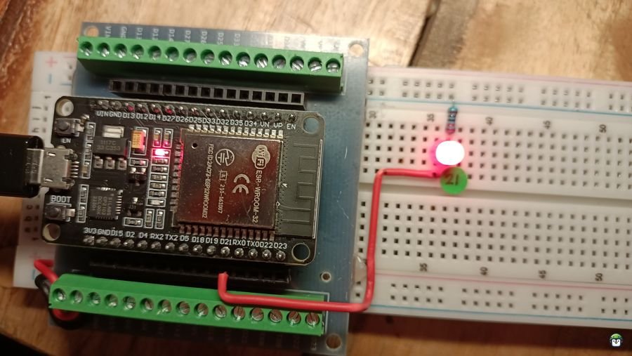 Photo of a circuit with an LED connected to GPIO21 on the ESP32, illuminated to indicate it is turned on.